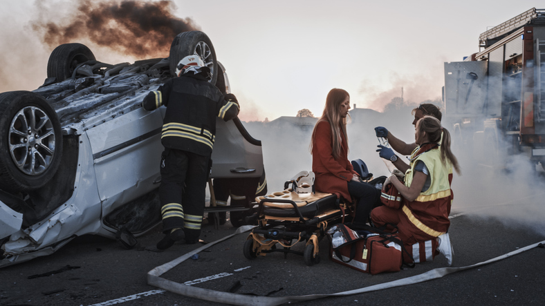 Medics Give First Aid to a Female Passenger after accident